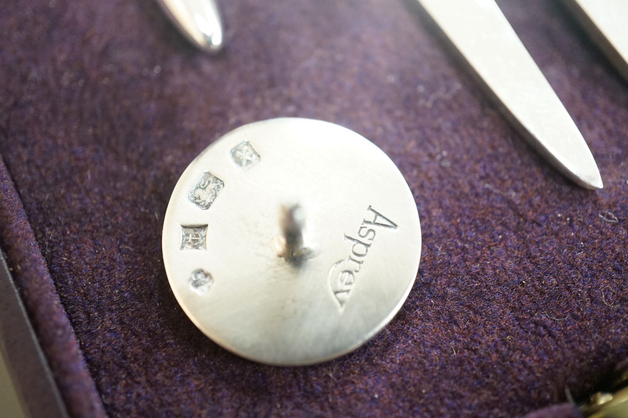 A modern Asprey cased silver golfer's companion set, comprising a tee, marker and pitch mark repairer, together with a set of six metal duck menu holders.